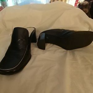 Black leather heeled mules.